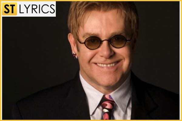 You can see Elton John smiling on the photo. img 0 Sir Elton John in his glasses that became an inseparable part of his style is a well-known not only pop-artist but also fighter for LGBT rights. img 0